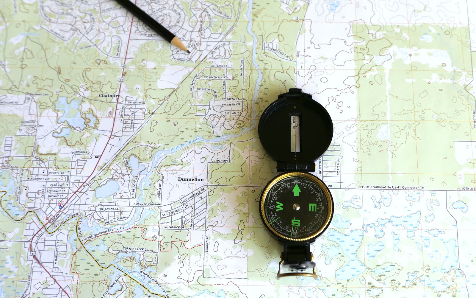 A topographic map with a compass and pencil